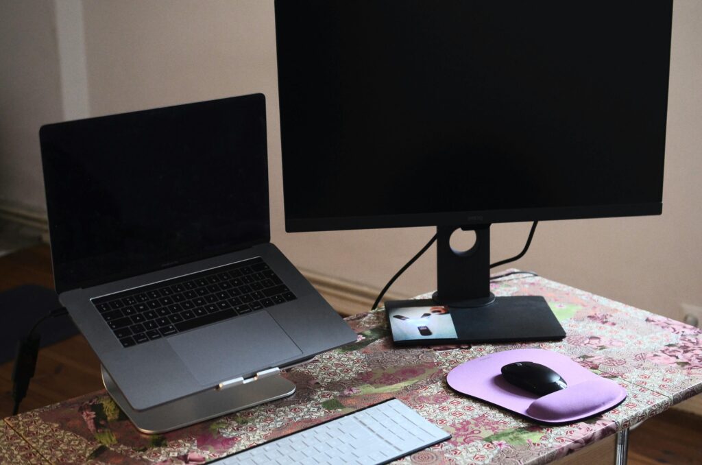 pexels-photo-6045231-6045231 A modern workspace featuring a laptop and monitor setup on a desk.